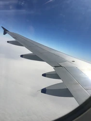 Airplane Wing View Above Clouds