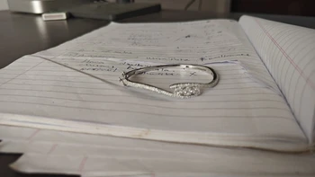 Diamond ring on handwritten notebook