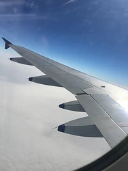 Airplane Wing View Above Clouds